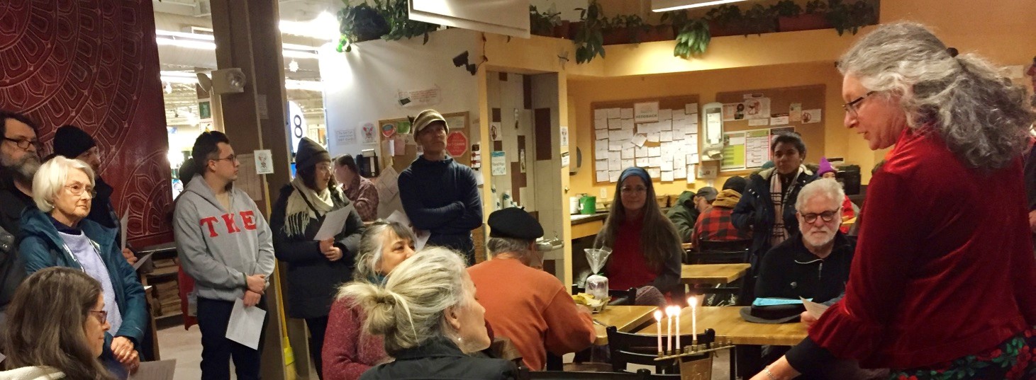 laura and group BAJC co-president Laura Berkowitz lights 3rd night candle at Brattleboro Co-op
Photo Credit: Stephan Brandstatter